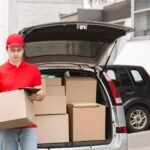 courier holds big box and checks address on tablet eku5v8b.jpg